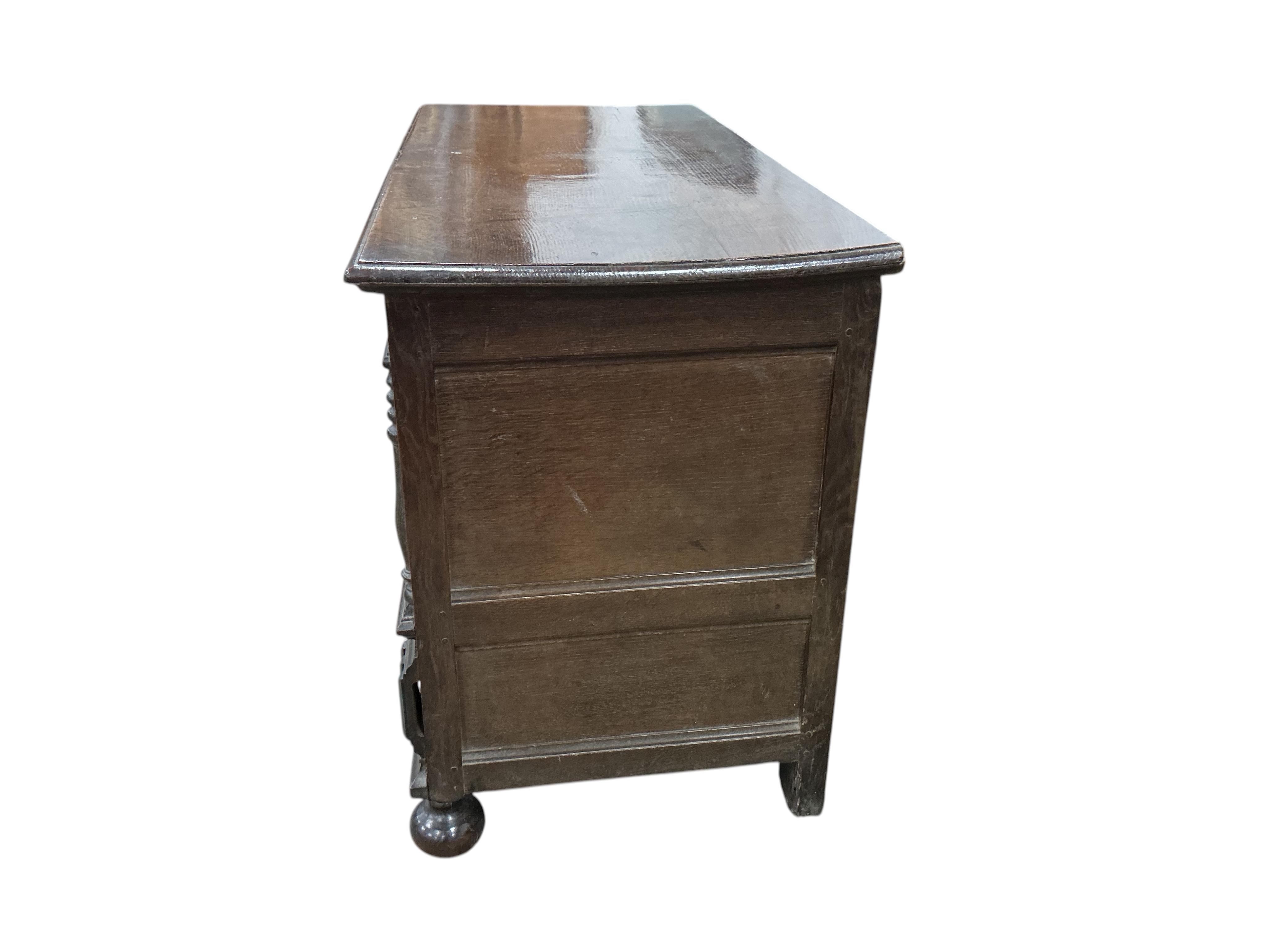 An 18th century panelled oak mule chest, carved with the initials M D, width 129cm, depth 57cm, height 83cm